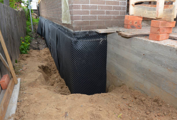 Happy homeowners after waterproofing job in Loretto